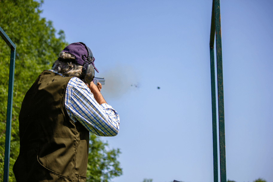 person shooting clay pigeons