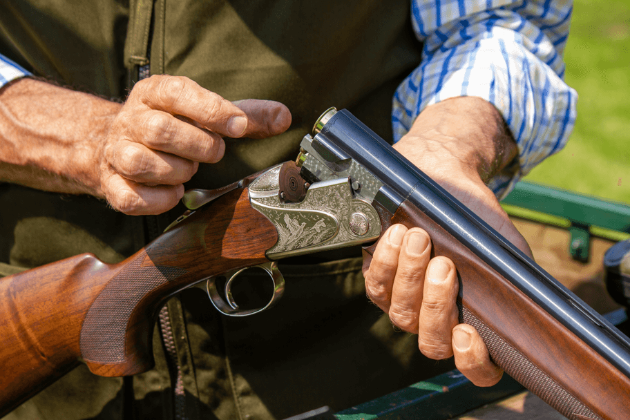 someone loading the gun for clay shooting